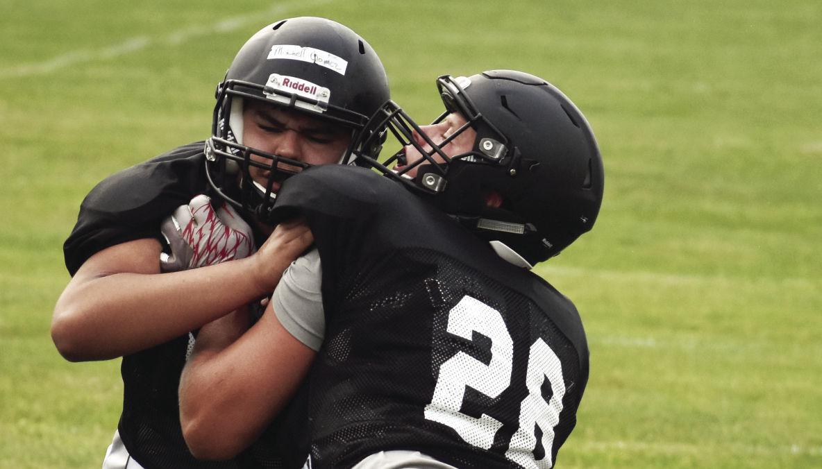 Prep football photo: Marshall linemen Kelby Petersen, Mitchell Gomez square off